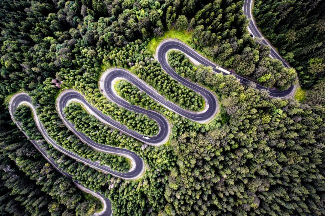 Winding road at sunset, drone aerial shot